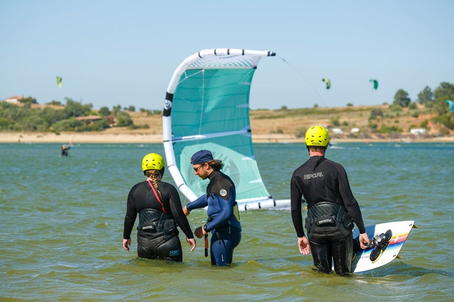 Two students and one instructor during semi private kitesurfing lesson