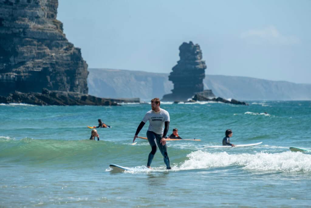 people surf in Praia da Arrifana Algarve, Portugal