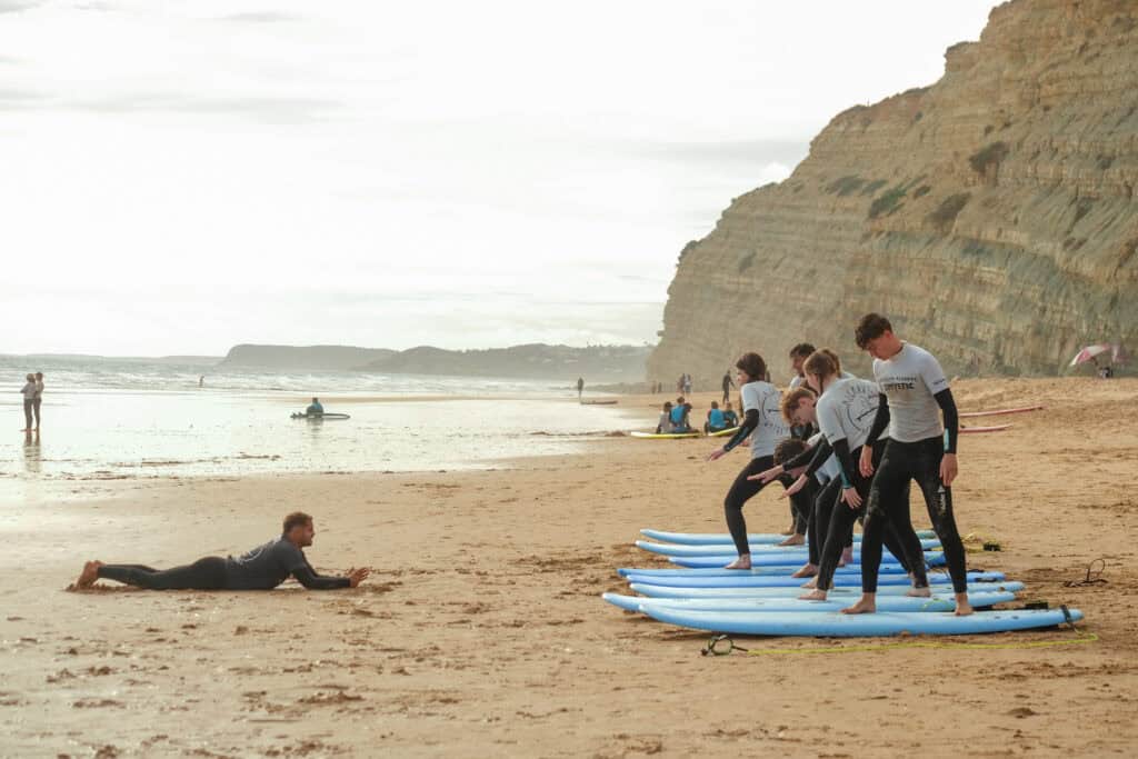 people surfing at Porto de Mos Algarve Portugal