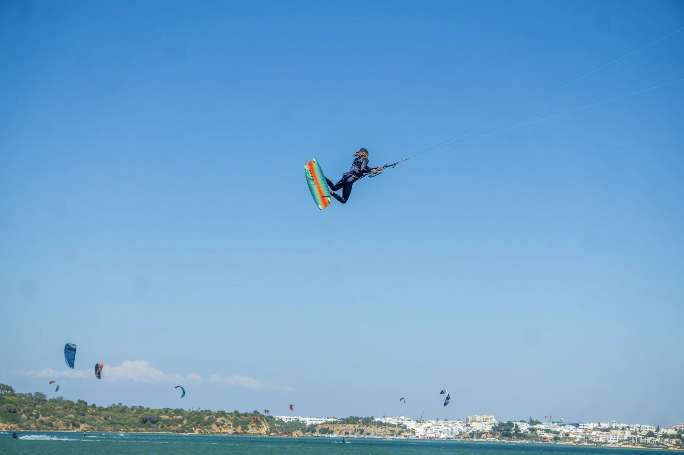 Kitesurf freestyle big air jump over Lagos coastline Algarve