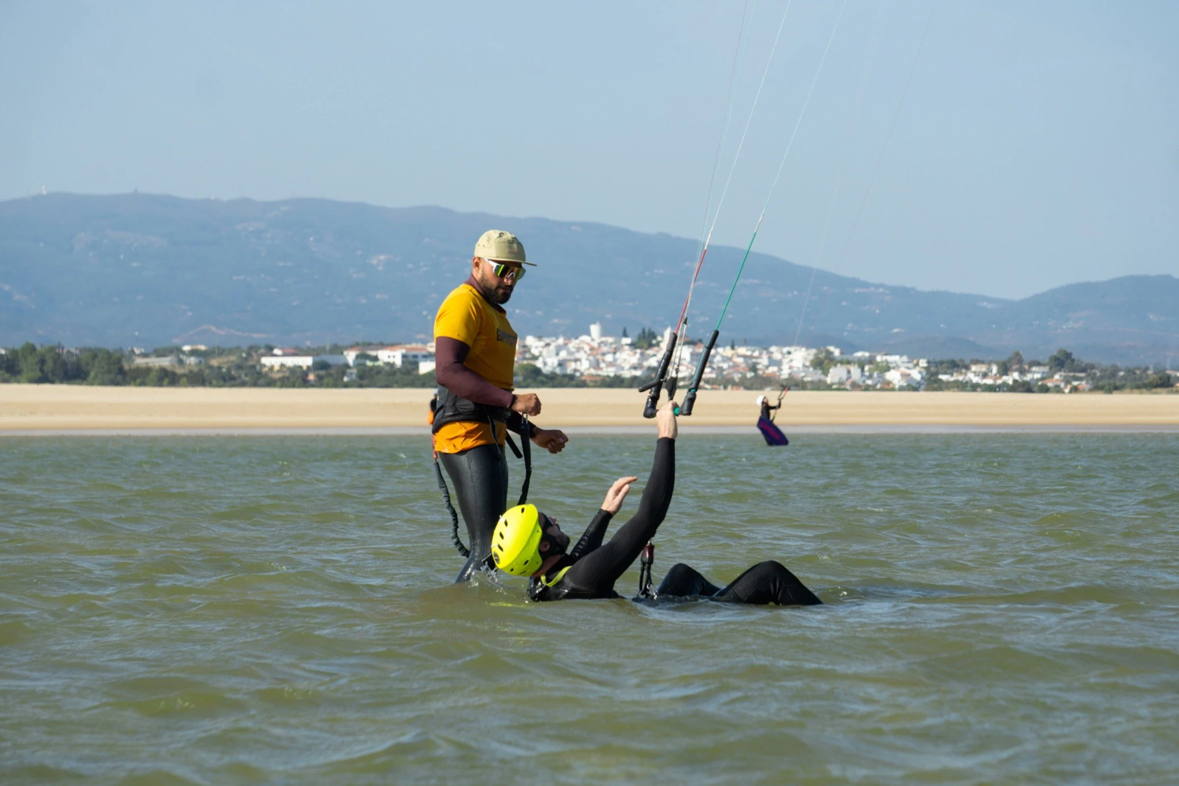 Kite instructor helping student with water start in Algarve