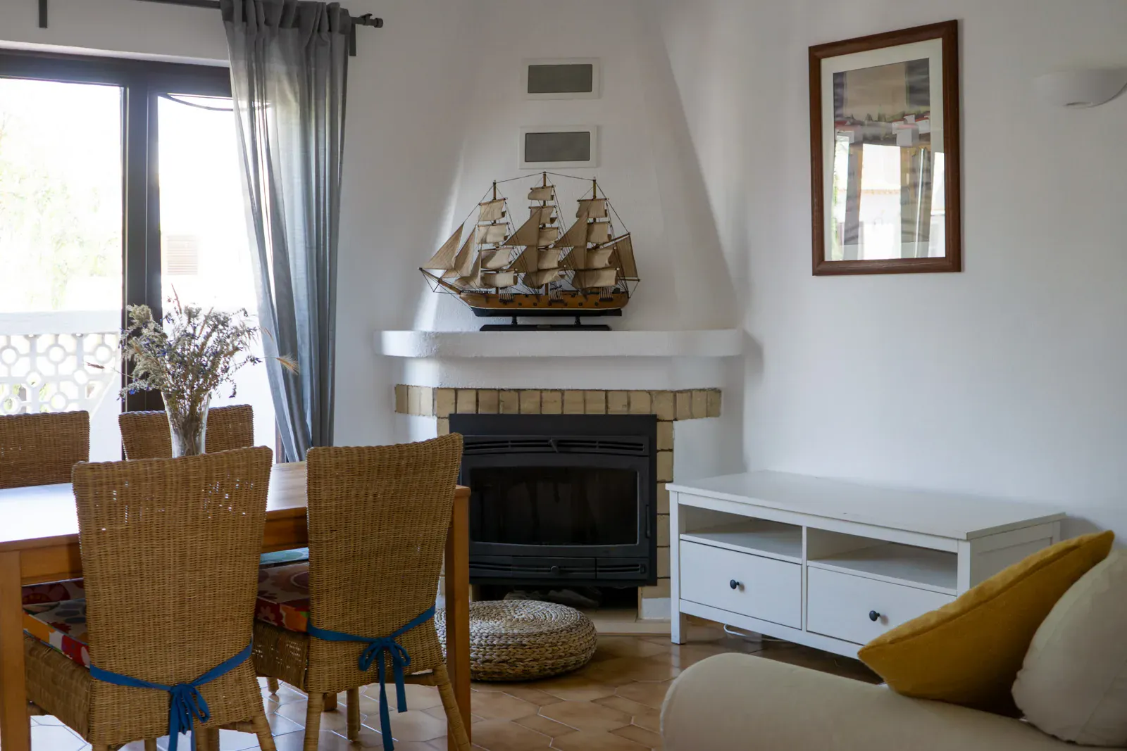 Palmito apartment living room with fireplace, TV and dining area at Algarve Watersport surf camp