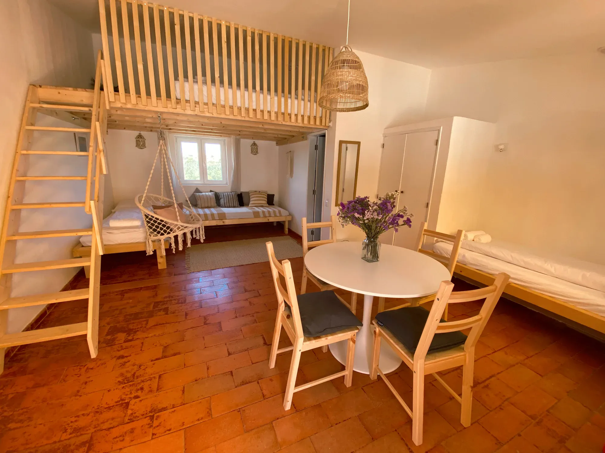 Dorm interior with loft beds and hammock at Algarve Watersport surf camp