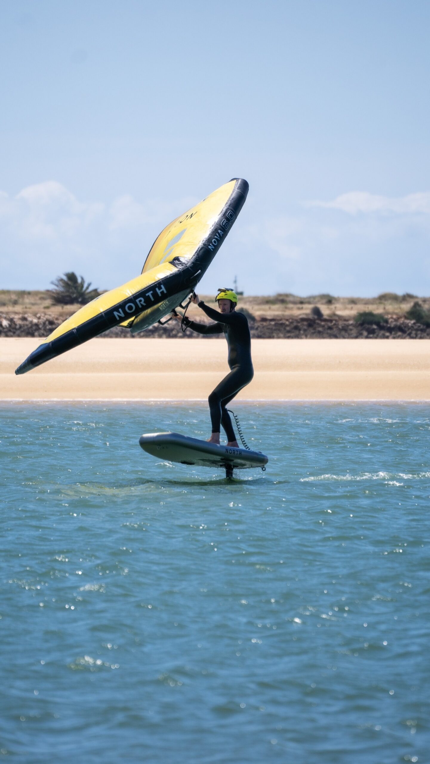 Intermediate wingfoil student foiling at Alvor lagoon